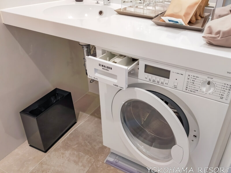 洗面台の下に白くコンパクトな洗濯乾燥機